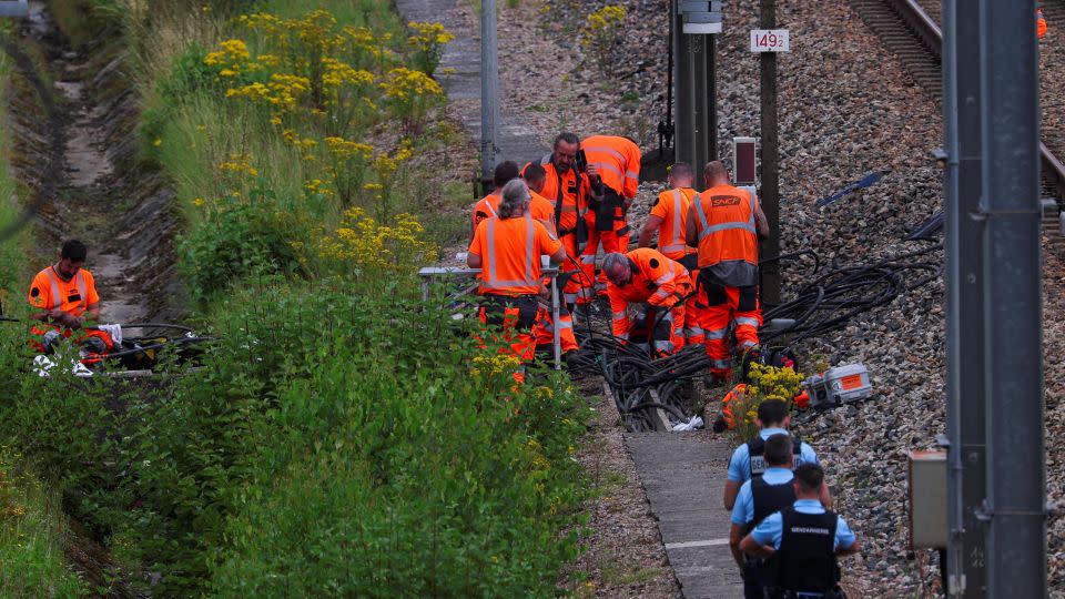 SNCF railway staff and police officers work at the site where vandals targeted France's high-speed train network in Croisilles, France, on Friday, July 26. - Brian Snyder/Reuters