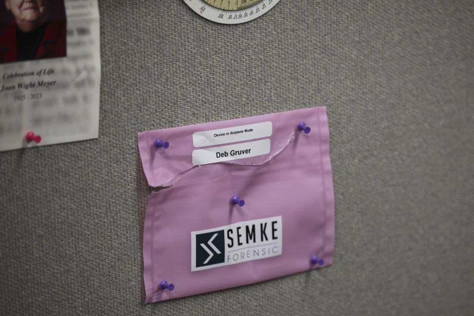 A bag that held Marion County Record reporter Deb Gruver's personal cellphone is pinned to the wall behind her desk in the Record's newsroom, Monday, Aug. 21, 2023, in Marion, Kansas. Police seized Gruver's cellphone and her computer tower in an Aug. 11, raid, and it was later turned over to a computer forensics auditing company hired by the newspaper's attorney, which put it in the bag. (AP Photo/John Hanna)