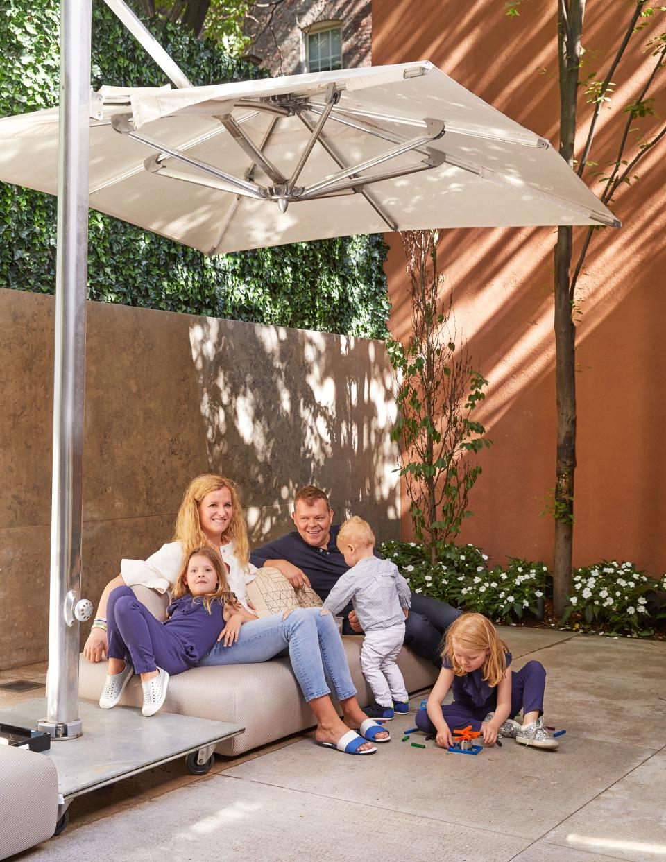 Verhoeven and Reijtenbagh with their children in the backyard, where the kids ride their bikes and play for hours at a time. “We spend most of our time there; it becomes an extension of the living room when we open the big sliding doors all the way,” says the CEO.