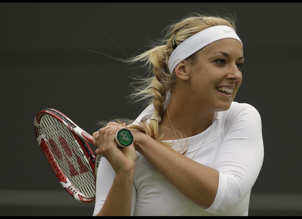 Sabine Lisicki of Germany plays a return to Maria Sharapova of Russia during a fourth round singles match at the All England Lawn Tennis Championships at Wimbledon, England, Monday, July 2, 2012.