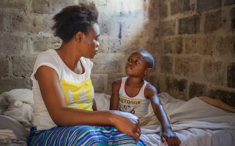 Young mother, Mirriam at home with her son Muhammad, 6, who survived cholera. Garden Compound. Lusaka, Zambia, May 2018. - Credit: Chileshe Chanda/WaterAid