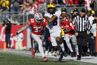 Michigan receiver Cornelius Johnson, front, outruns Ohio State defenders Cameron Brown, right, and Brenten Jones to score a touchdown during the first half of an NCAA college football game on Saturday, Nov. 26, 2022, in Columbus, Ohio. (AP Photo/Jay LaPrete)