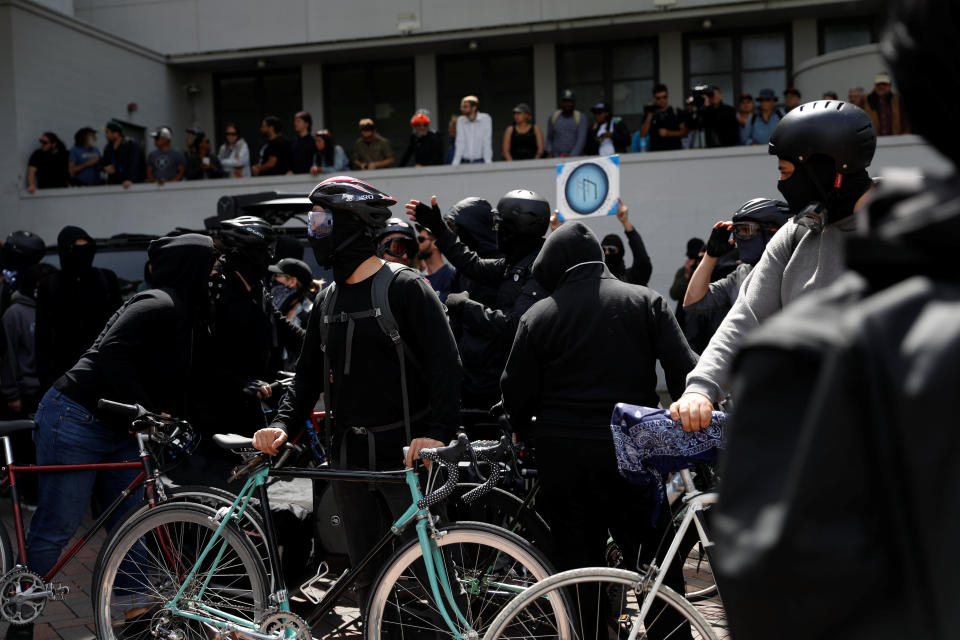 Masked demonstrators against U.S. President Donald Trump rally in Berkeley, California in Berkeley, California, U.S., April 15, 2017. REUTERS/Stephen Lam