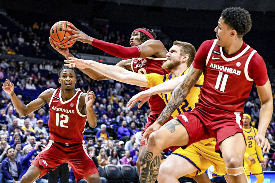 Arkansas' El Ellis (3) beats LSU forward Hunter Dean (12) to a loose ball during an NCAA college basketball game at Pete Maravich Assembly Center, Saturday, Feb. 3, 2024, Baton Rouge, La. (Javier Gallegos/The Advocate via AP)