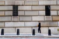 A man walks past the barred windows of the Federal Reserve Bank of New York in the Manhattan borough of New York City