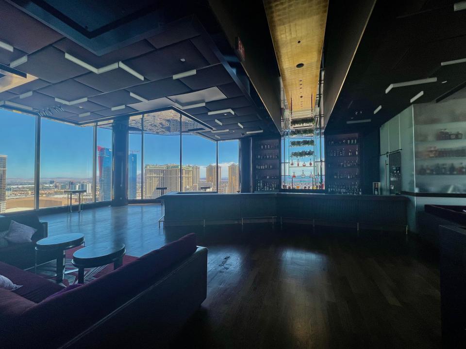 A mostly empty bar room with views of Las Vegas.