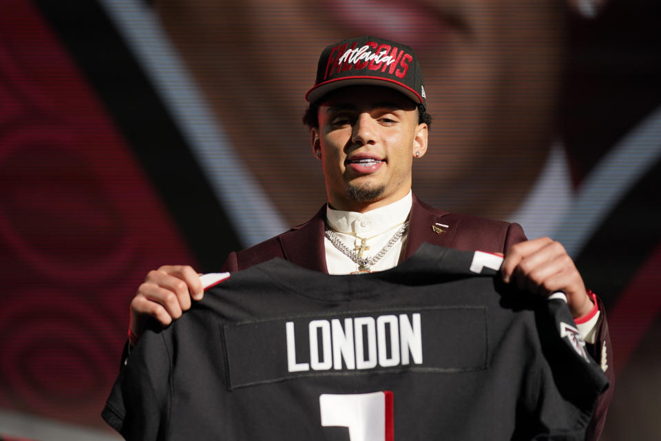 Southern California wide receiver Drake London holds a jersey after being chosen by the Atlanta Falcons with the eighth pick of the NFL football draft Thursday, April 28, 2022, in Las Vegas. (AP Photo/John Locher)