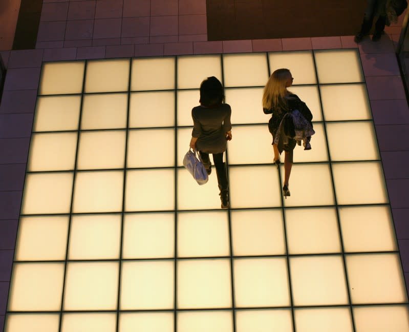 Women walk through a shopping mall in San Francisco