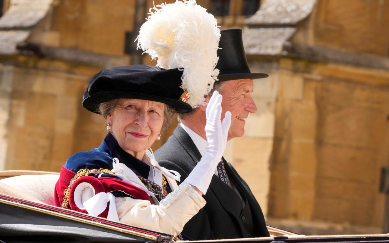 Princess Anne and her husband Tim Laurence ride in a carriage after attending the Order of the Garter service, which is held at St George's Chapel at Windsor Castle