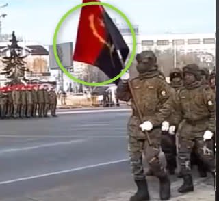 <span>Screenshot showing the red and black Angola flag with a yellow emblem of a machete, a star, and half of a cogwheel </span>