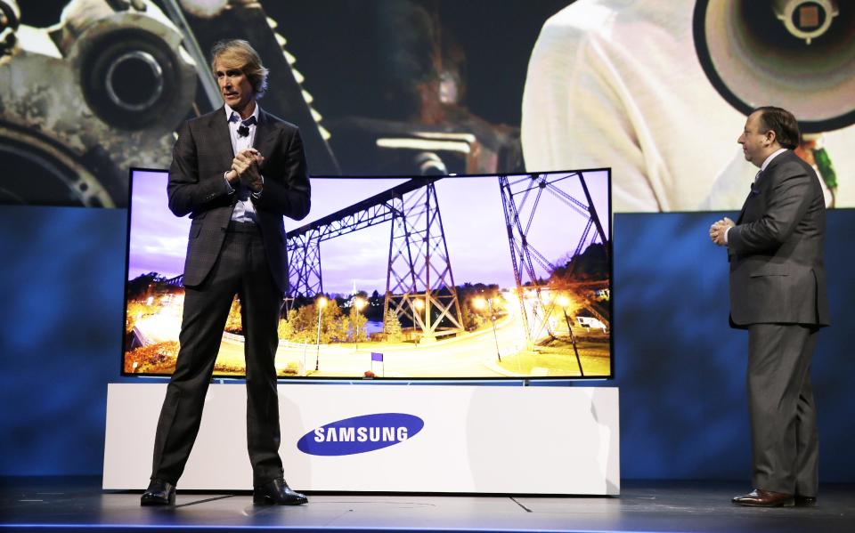 Director Michael Bay, left, and Samsung Electronics America Executive Vice President Joe Stinziano introduce a 105-inch ultra high definition curved television during a news conference at the International Consumer Electronics Show, Monday, Jan. 6, 2014, in Las Vegas. (AP Photo/Isaac Brekken)