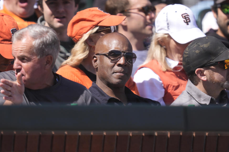 Former baseball player Barry Bonds, center, looks on during the fifth inning of a baseball game between the San Francisco Giants and the San Diego Padres in San Francisco, Friday, April 5, 2024. (AP Photo/Eric Risberg)