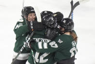 Boston forward Jamie Lee Rattray, left, forward Taylor Wenczkowski, center, and defenseman Jess Healey, right, celebrate with teammates after Boston scored during the second period in Game 1 of a PWHL hockey championship series, Sunday, May 19, 2024, in Lowell, Mass. (AP Photo/Steven Senne)
