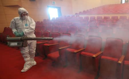 A worker in full protective gear disinfects an art hall in Seoul, South Korea, June 12, 2015. REUTERS/Seo Myeong-gon/Yonhap