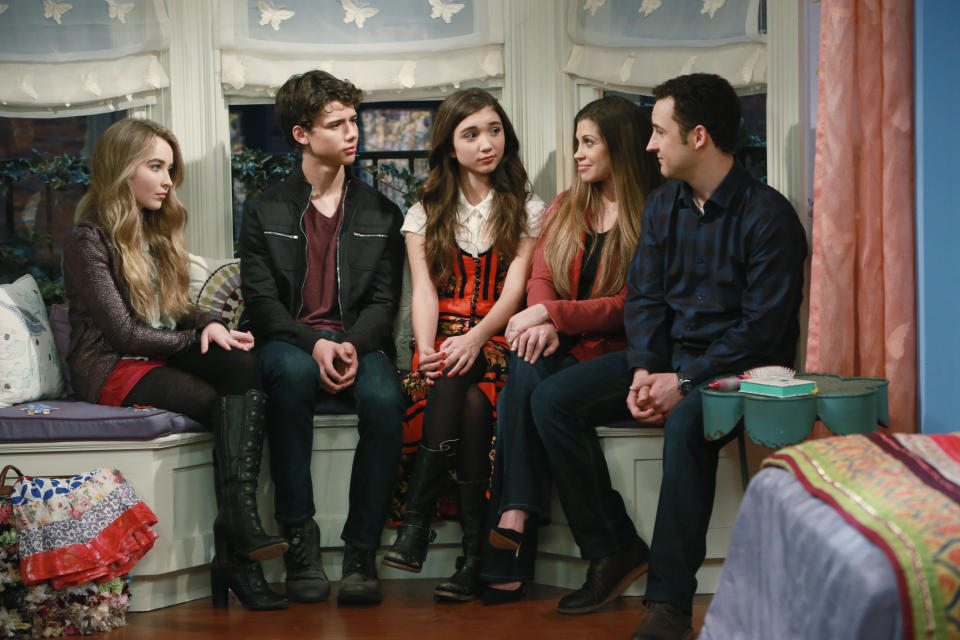 Maya, Josh, Maya, Topanga, and Cory sitting together on the window seat in Riley's room