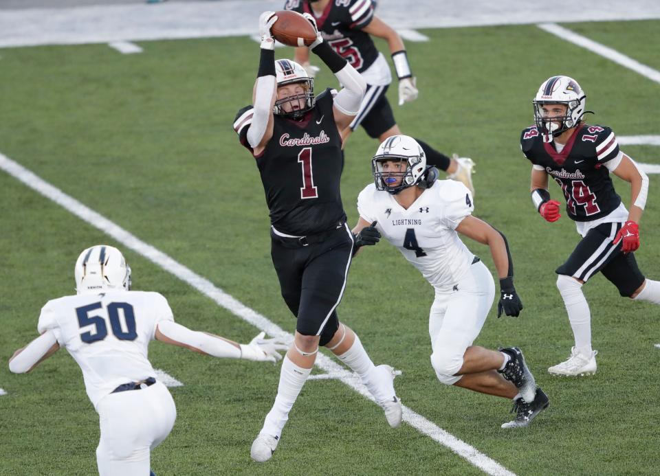 Fond du Lac High School's Max Mengel (1) pulls down a first down reception against Appleton North High School's Ben Wenzel (50) and Bobby Salm (4) during their football game Thursday, August 31, 2023, in Fond du Lac, Wis. 
Dan Powers/USA TODAY NETWORK-Wisconsin.