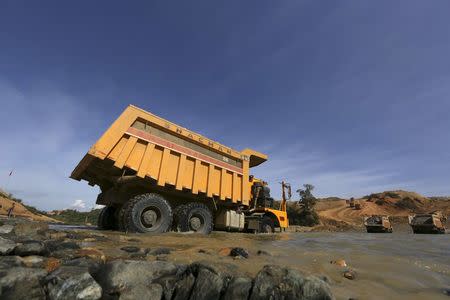 Trucks are seen at a jade stones mine dump at a Hpakant jade mine in Kachin state, Myanmar November 26, 2015. REUTERS/Soe Zeya Tun