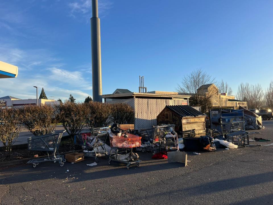 Garbage piles up near a growing RV homeless camp in a parking lot in the 1200 block of Lancaster Drive NE on March 15 in front of WinCo Foods and Coastal Farm & Ranch.