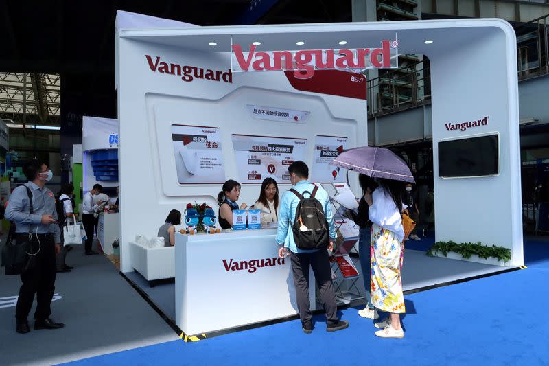 FILE PHOTO: People are seen at a booth of Vanguard Group at a fair during the INCLUSION fintech conference in Shanghai