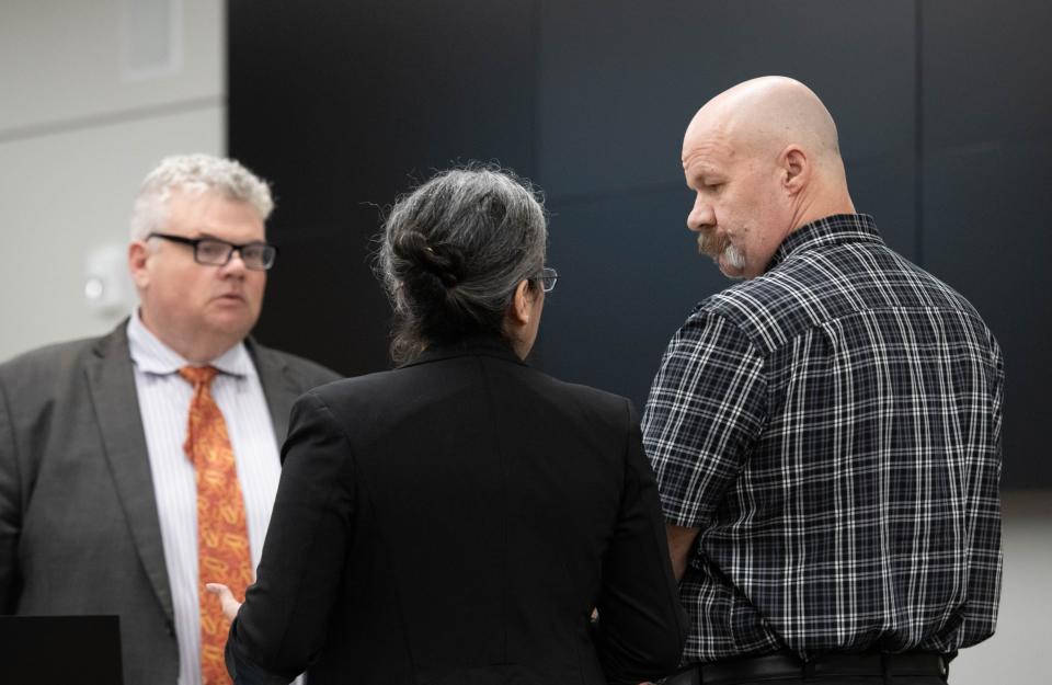 Jason Curtis, right, talks with his attorneys during his trial at the Santa Rosa County Courthouse in Milton on Tuesday, April 30, 2024.