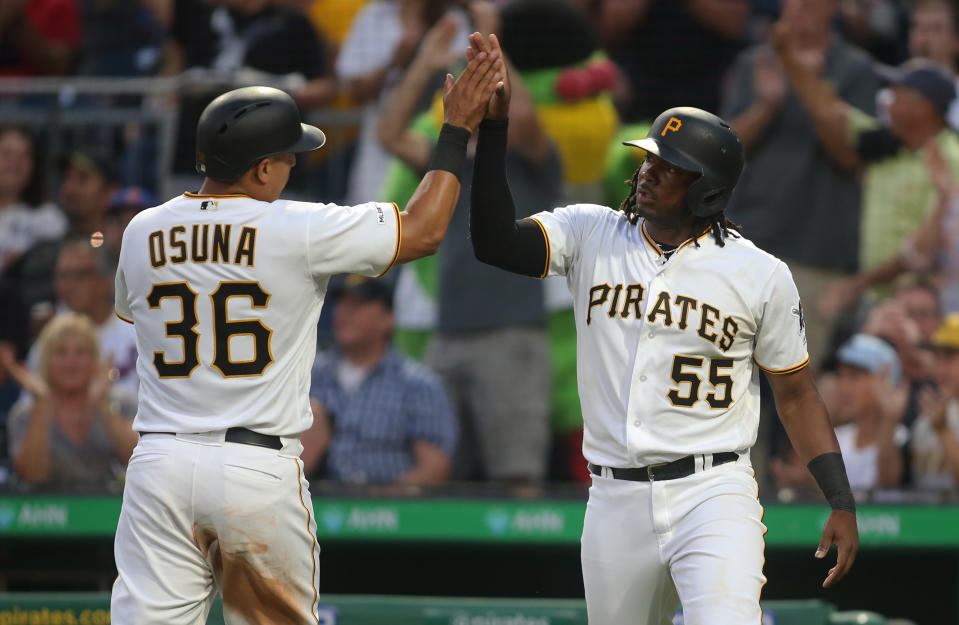 Aug 2, 2019; Pittsburgh, PA, USA;  Pittsburgh Pirates third baseman Jose Osuna (36) and first baseman Josh Bell (55) celebrate after scoring runs against the New York Mets fourth inning at PNC Park. Mandatory Credit: Charles LeClaire-USA TODAY Sports