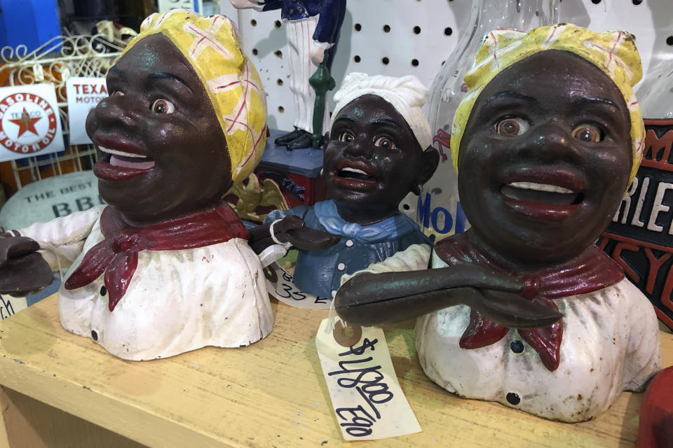 Cookie jars and other figurines modeled after a "Mammy" image are for sale at the Exit 76 Antique Mall in Edinburgh, Indiana, Tuesday, July 21, 2020. U.S. Rep. Greg Pence is coming under criticism for allowing the sale of objects with racist depictions of African Americans at the sprawling antiques mall he co-owns. (AP Photo/Casey Smith)