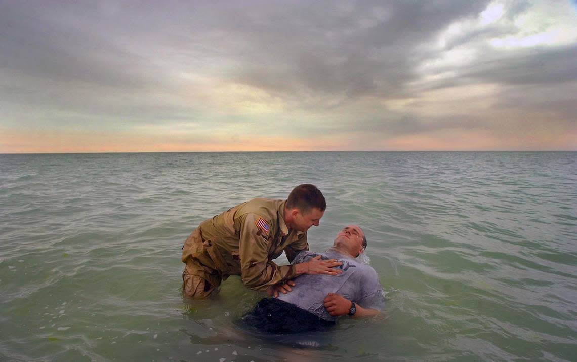 82 Airborne Chaplin Capt. Eddie Cook baptizes Specialist Nick Valaitis of the 3-325 Fort Bragg 82nd Airborne Monday afternoon in the waters of the Persian Gulf.