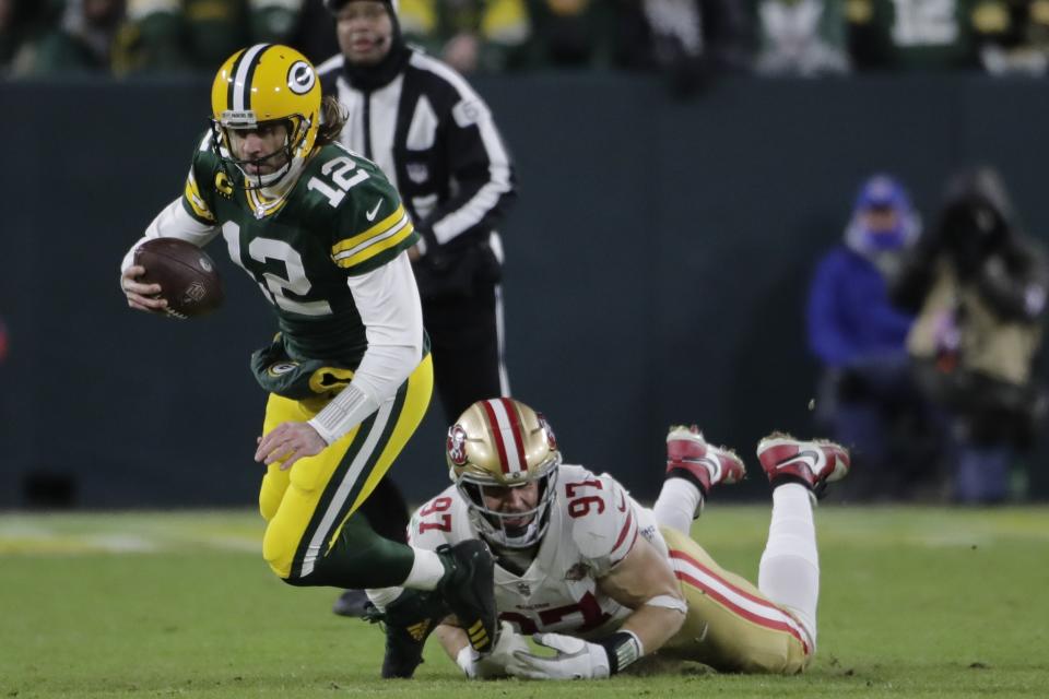 San Francisco 49ers' Nick Bosa sacks Green Bay Packers' Aaron Rodgers during the first half of an NFC divisional playoff NFL football game Saturday, Jan. 22, 2022, in Green Bay, Wis. (AP Photo/Aaron Gash)