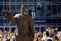 Former Nashville Predators goaltender Pekka Rinne, right, admires his statue during an unveiling ceremony before an NHL hockey game between the Nashville Predators and the Seattle Kraken, Saturday, March 25, 2023, in Nashville, Tenn. (AP Photo/Mark Zaleski)