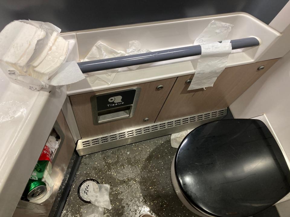 A messy bathroom on an LNER train.