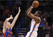 Oklahoma City Thunder forward Kevin Durant shoots over Detroit Pistons guard Kyle Singler during the first quarter of an NBA basketball game in Oklahoma City, Wednesday, April 16, 2014. (AP Photo/Sue Ogrocki)