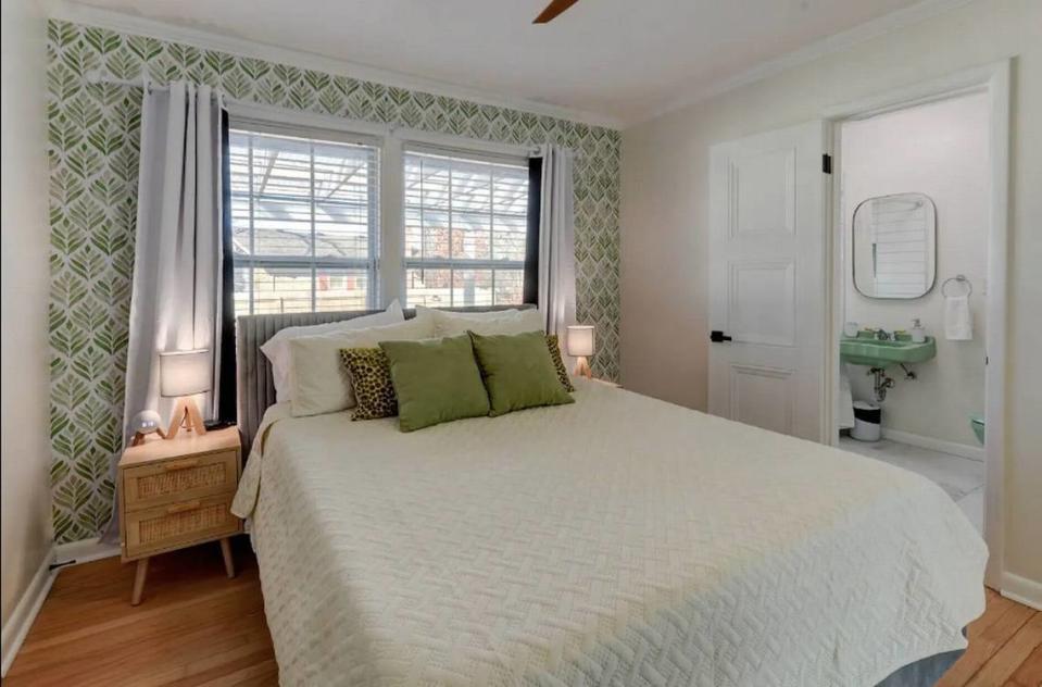 One of the bedrooms has the original 1950s green sink and tub in the adjoining bathroom.