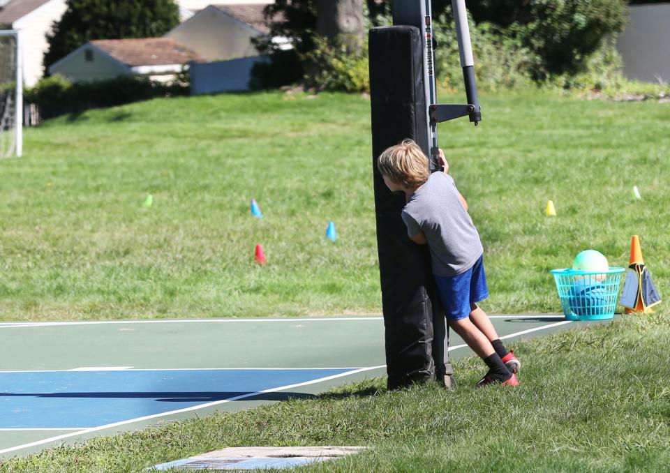 A student at Maude H. Trefethen School in New Castle plays hide-and-seek during recess Aug. 31, 2023.