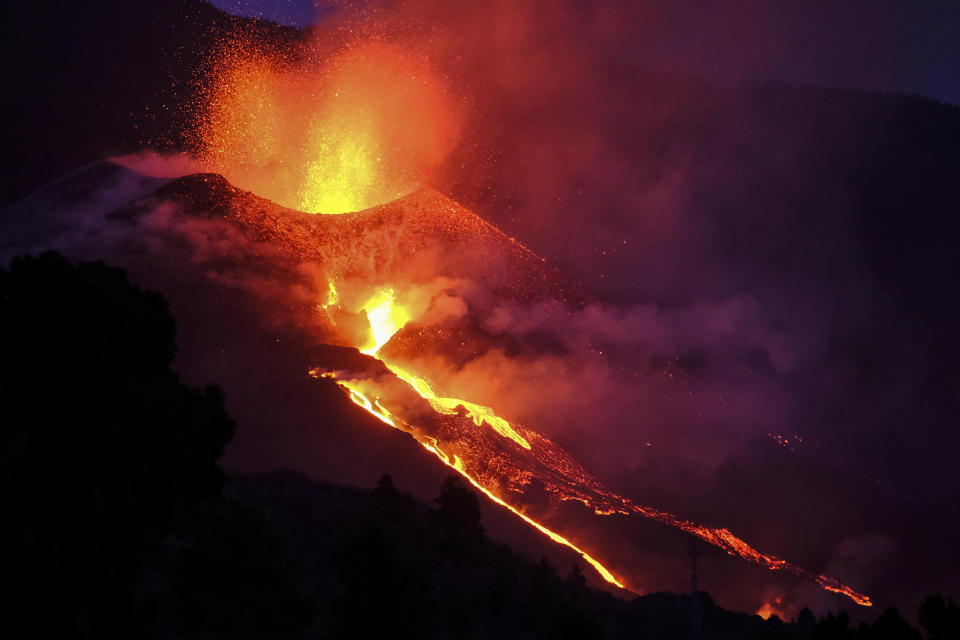 Lava flows from a volcano on the Canary island of La Palma, Spain, Saturday Oct. 2, 2021. An erupting volcano on a Spanish island off northwest Africa has blown open another fissure on its hillside. The new fissure is the third to crack open since the Cumbre Vieja crater erupted on La Palma island Sept. 19. (AP Photo/Daniel Roca)