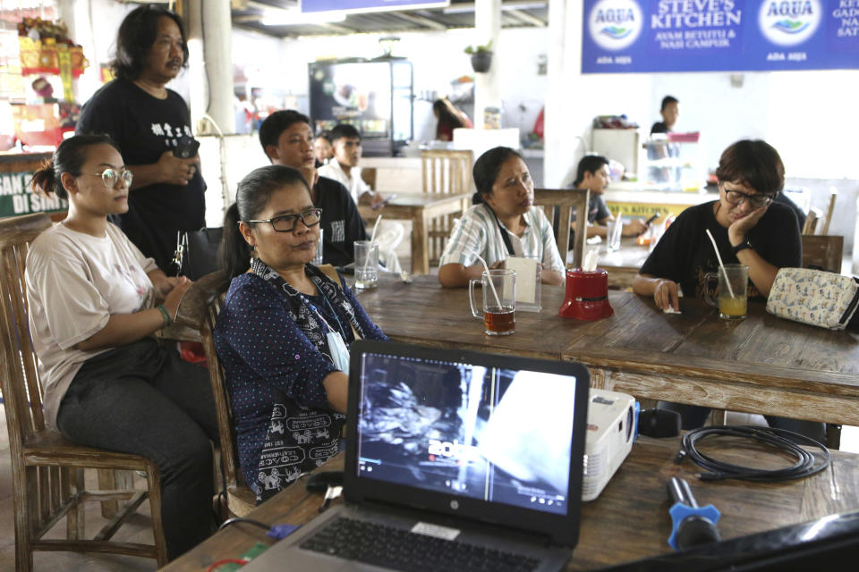 Survivors watch a documentary on a 2002 bombing in Denpasar in Bali, Indonesia, Sunday, Oct. 9, 2022. The attack, in which 202 people were killed, catapulted Indonesia onto the front lines of the international war on terror and forced the world's largest Muslim country to confront a growing extremist fringe in its midst. (AP Photo/Firdia Lisnawati)