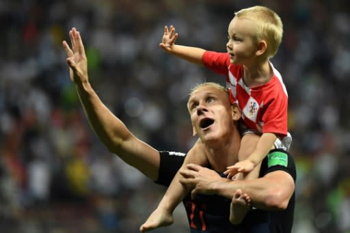 Croatia defender Domagoj Vida celebrates with his son after victory against England in the World Cup semi-finals