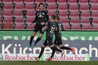 Bremen's Joshua Sargent, left, celebrates scoring with teammates Marco Friedl and Ludwig Augustinsson, right, during the German Bundesliga soccer match between 1. FC Cologne and Werder Bremen in Cologne, Germany, Sunday, March 7, 2021. (Rolf Vennenbernd/dpa via AP)