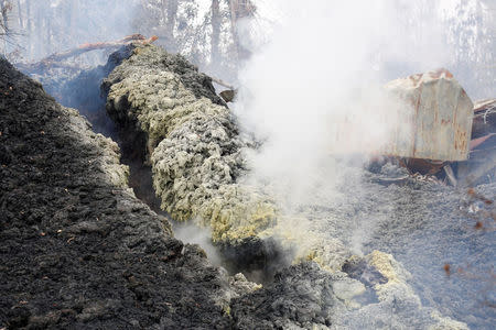 Volcanic gases rise from a fissure near the remains of a structure in the Leilani Estates subdivision during ongoing eruptions of the Kilauea Volcano in Hawaii, U.S., May 13, 2018. REUTERS/Terray Sylvester