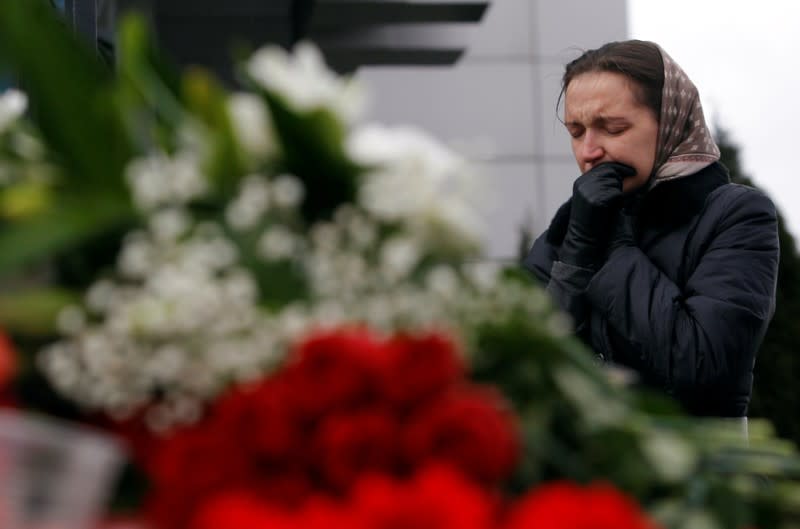 FILE PHOTO: Woman mourns near flowers left outside Kazan airport, where a Tatarstan Airlines Boeing 737 crashed