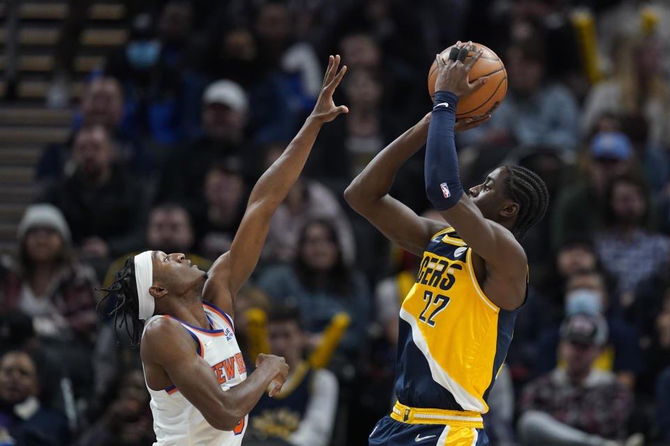 Indiana Pacers' Caris LeVert (22) shoots over New York Knicks' Immanuel Quickley (5) during the first half of an NBA basketball game Wednesday, Dec. 8, 2021, in Indianapolis. (AP Photo/Darron Cummings)