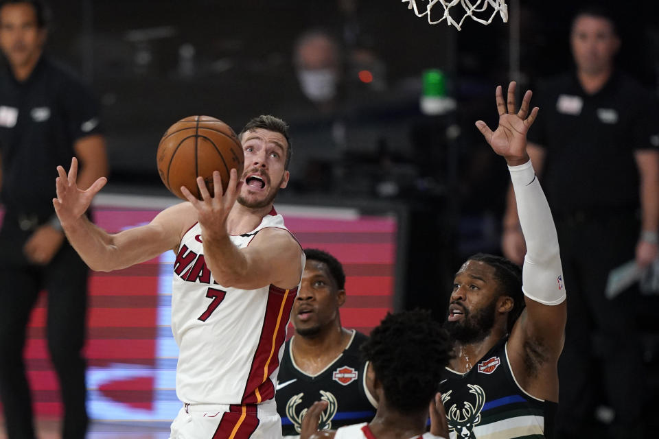 FILE - Miami Heat's Goran Dragic (7) puts up a shot against Milwaukee Bucks' Wesley Matthews (9), right, during the first half an NBA conference semifinal playoff basketball game Wednesday, Sept. 2, 2020, in Lake Buena Vista, USA. Goran Dragic, a former All-Star guard with the Miami Heat and the leader of Slovenia’s team that won the EuroBasket championship in 2017, has announced his retirement. (AP Photo/Mark J. Terrill, File)