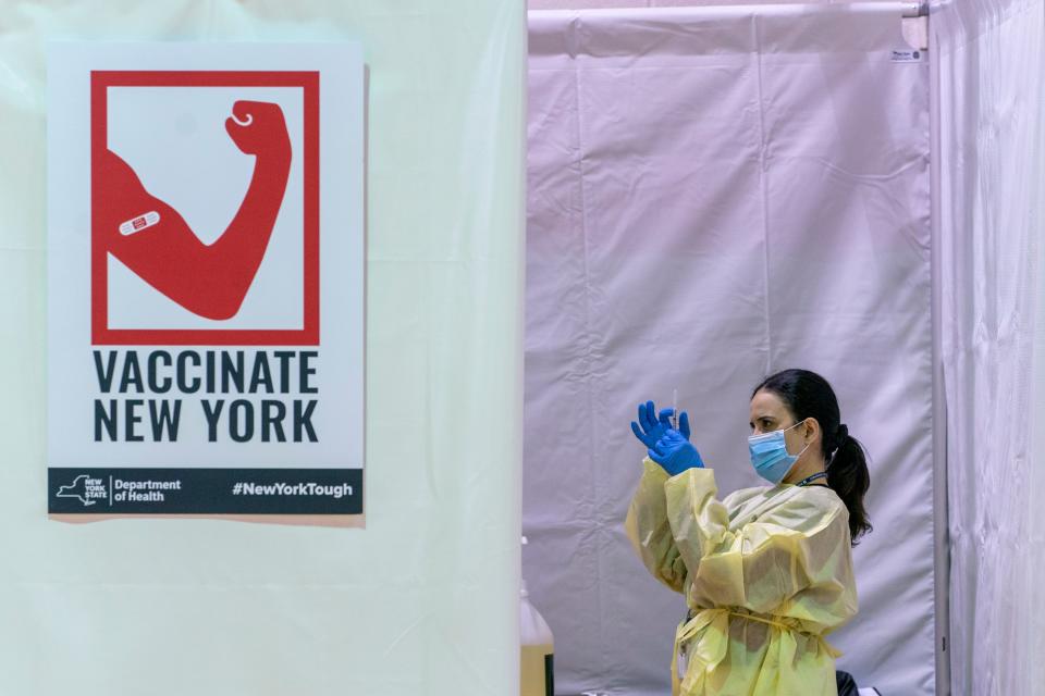 Registered Nurse Rita Alba prepares a syringe before vaccinating a patient on Sunday at a pop-up COVID-19 vaccination site at the Bronx River Community Center in New York.