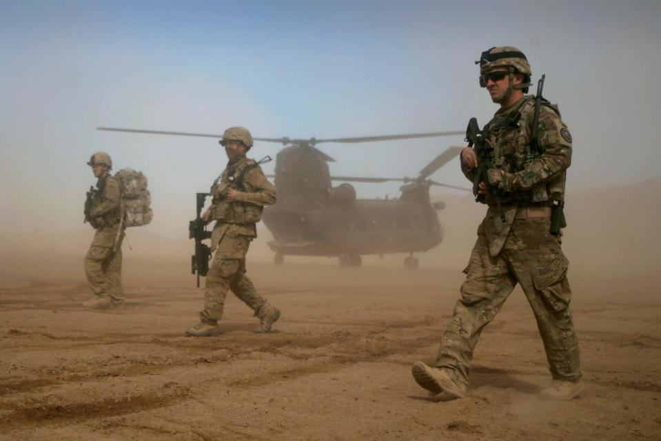 FILE - In this Jan. 28, 2012 file photo, U.S. soldiers, part of the NATO- led International Security Assistance Force (ISAF) patrol west of Kabul, Afghanistan. After 20 years of military engagement and billions of dollars spent, NATO and the United States still grapple with the same, seemingly intractable conundrum â€” how to withdraw troops from Afghanistan without abandoning the country to even more mayhem. (AP Photo/Hoshang Hashimi, File)