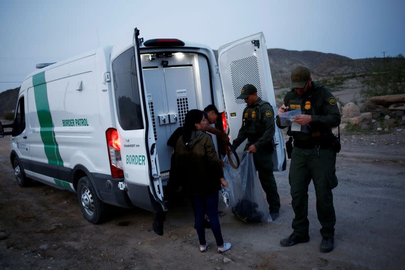 FILE PHOTO: Migrants from Central America crossing into the United States from Mexico, in New Mexico