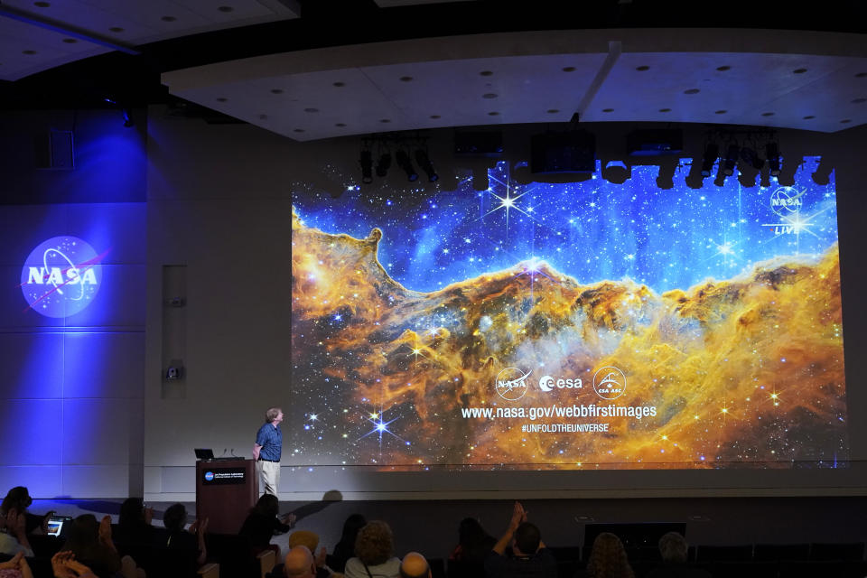 Michael Ressler, Project Scientist for the JWST Mid-Infrared Instrument, speaks in front of an image of the Carina Nebula, captured on the James Webb Space Telescope, during a news conference at the NASA Jet Propulsion Laboratory Tuesday, July 12, 2022, in Pasadena, Calif. (AP Photo/Marcio Jose Sanchez)