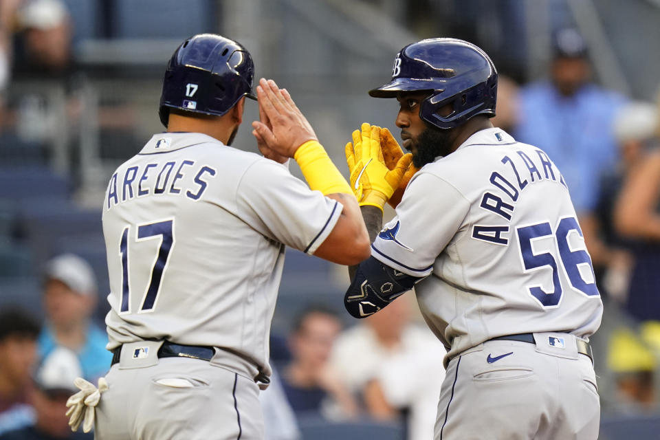 Tampa Bay Rays' Randy Arozarena (56) celebrates with Isaac Paredes (17) after Arozarena hit a three-run home run against the New York Yankees during the first inning of a baseball game Tuesday, Aug. 16, 2022, in New York. (AP Photo/Frank Franklin II)