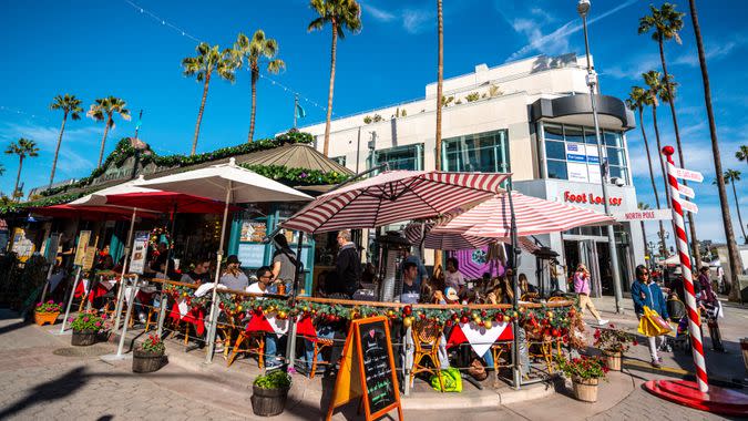 Santa Monica, USA - December 25, 2015: People eating outdoors in Santa Monica downtown in a cafe decorated for Christmas holidays.