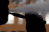 Daryl Cura demonstrates an e-cigarette at Vape store in Chicago, Wednesday, April 23, 2014. The federal government wants to ban sales of electronic cigarettes to minors and require approval for new products and health warning labels under regulations being proposed by the Food and Drug Administration. (AP Photo/Nam Y. Huh)