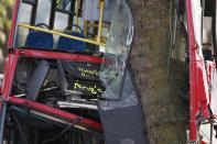 The front of the top deck a bus which crashed into a tree is crumpled by the impact in Kennington, south London, December 20, 2013. 23 people were injured, two seriously, in the crash according to the Metropolitan Police. REUTERS/Suzanne Plunkett (BRITAIN - Tags: DISASTER TRANSPORT)