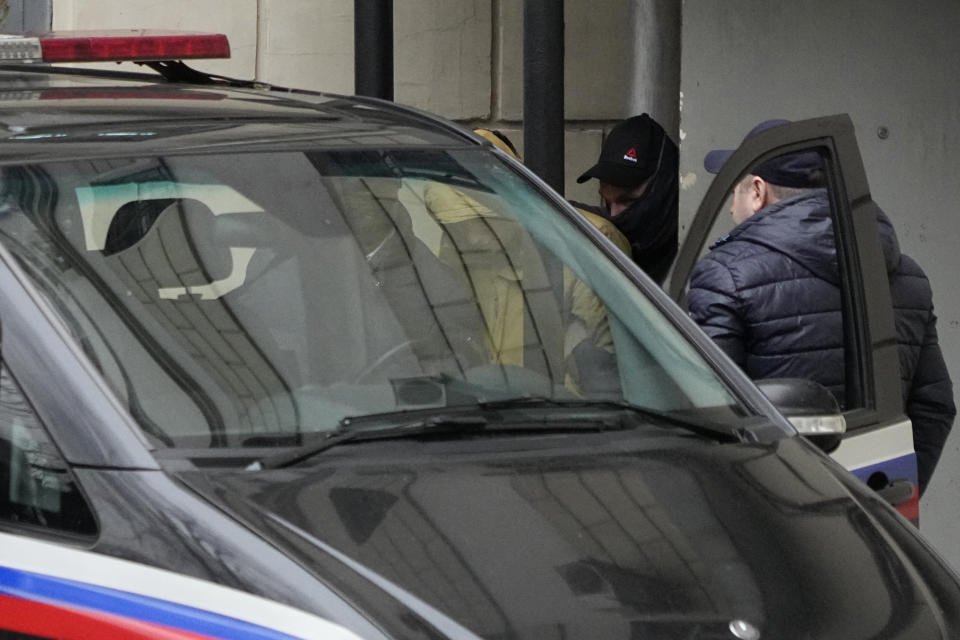 Reporter for the Wall Street Journal Evan Gershkovich, centre, is escorted by officers from the Lefortovsky court to a vehicle, in Moscow, Russia, Thursday, March 30, 2023. Russia's top security agency says an American reporter for the Wall Street Journal has been arrested on espionage charges. The Federal Security Service said Thursday that Evan Gershkovich was detained in the Ural Mountains city of Yekaterinburg while allegedly trying to obtain classified information. (AP Photo/Alexander Zemlianichenko)